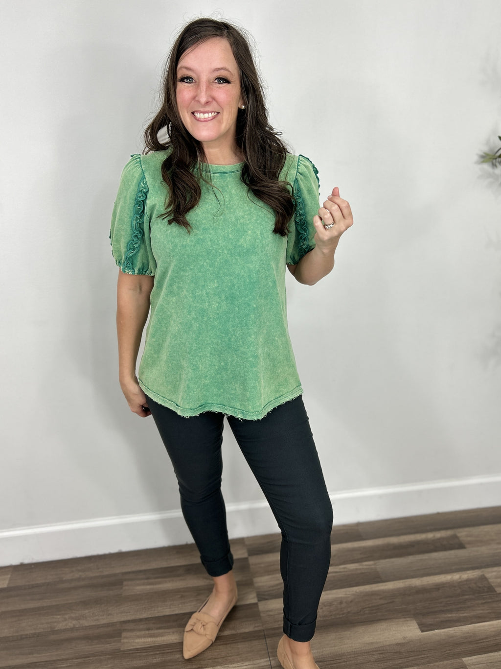 Women's Adaline mineral washed puff sleeve top in green paired with charcoal skinny jeans.
