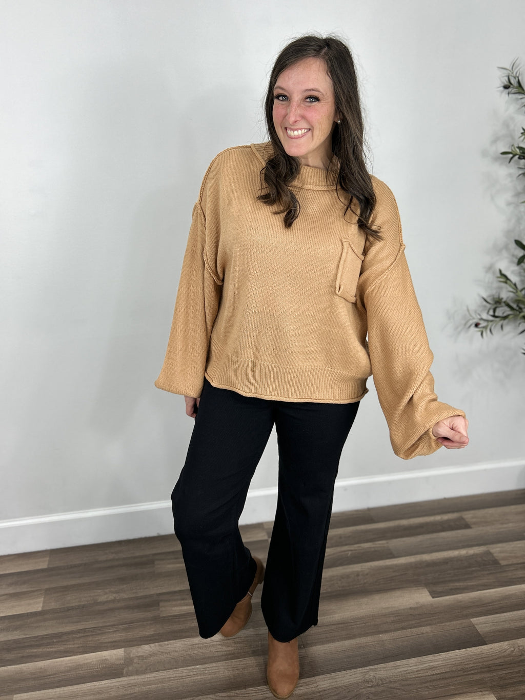 Baker oversized chunky sweater main photo in styled outfit with black crop jeans and boots.