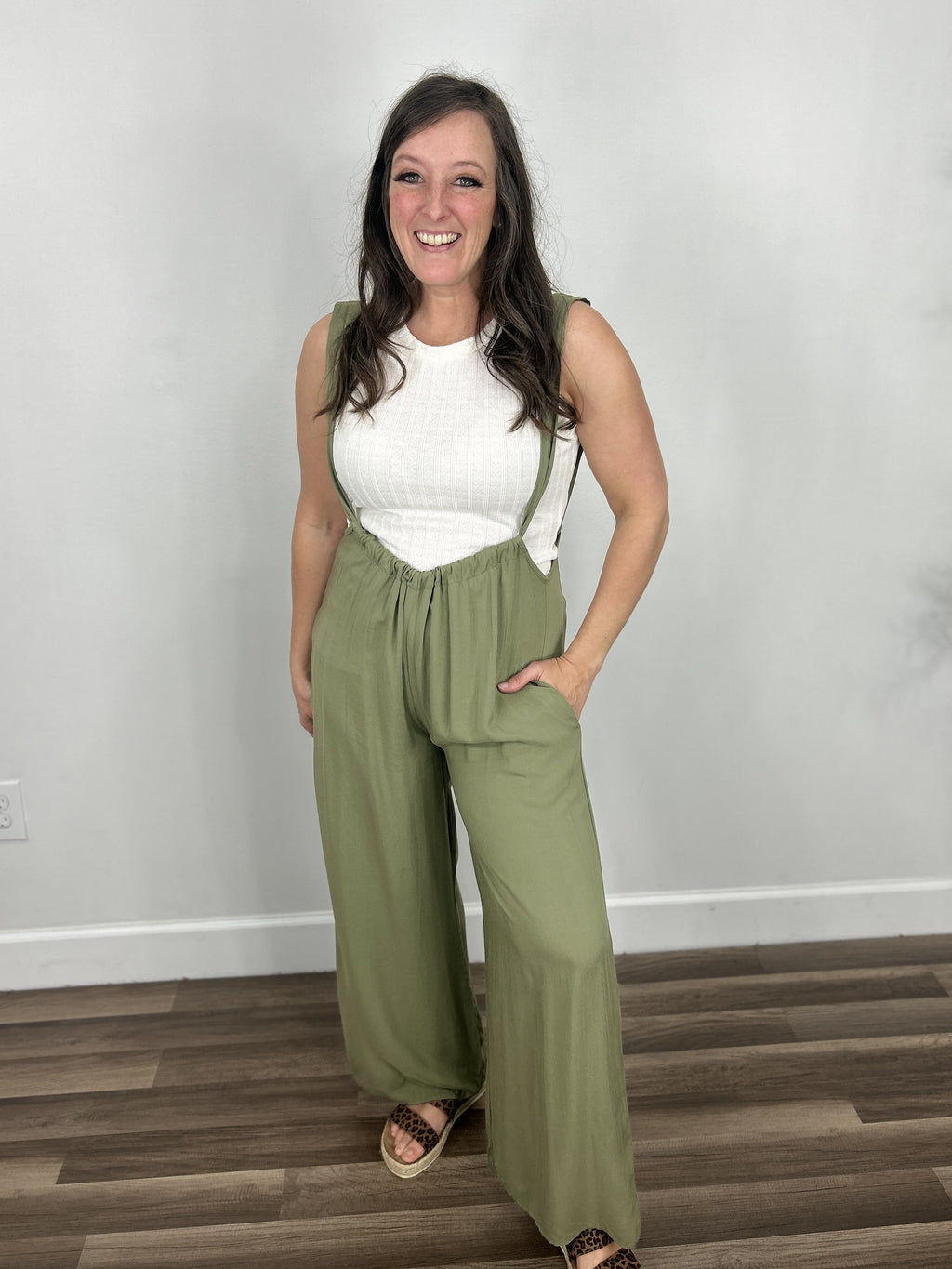 Carrigan casual wide leg jumpsuit paired with cream tank and sandals.