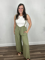 Load image into Gallery viewer, Carrigan casual wide leg jumpsuit paired with cream tank and sandals.
