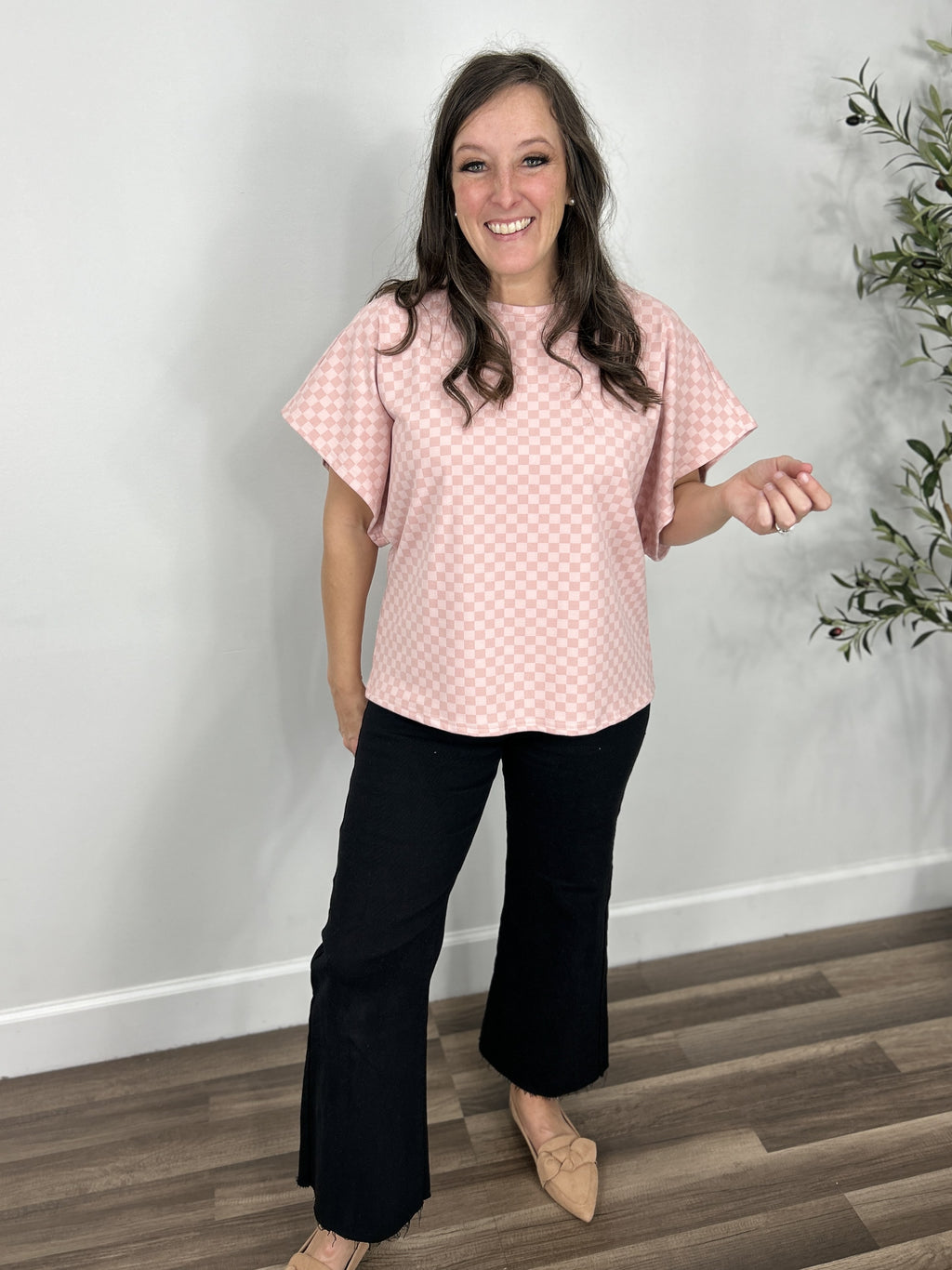 Claire two tone pink checker dolman sleeve top paired with black crop pants and light taupe flats. 