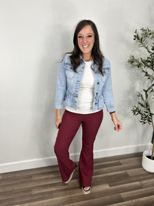Outfit styled with the Emma Peplum Lightwash Denim Jacket. Layered over a ivory tank top and paired with maroon stretch flare pants.