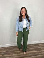 Load image into Gallery viewer, Emma Peplum lightwash denim jacket styled with white tank and green straight leg pants.
