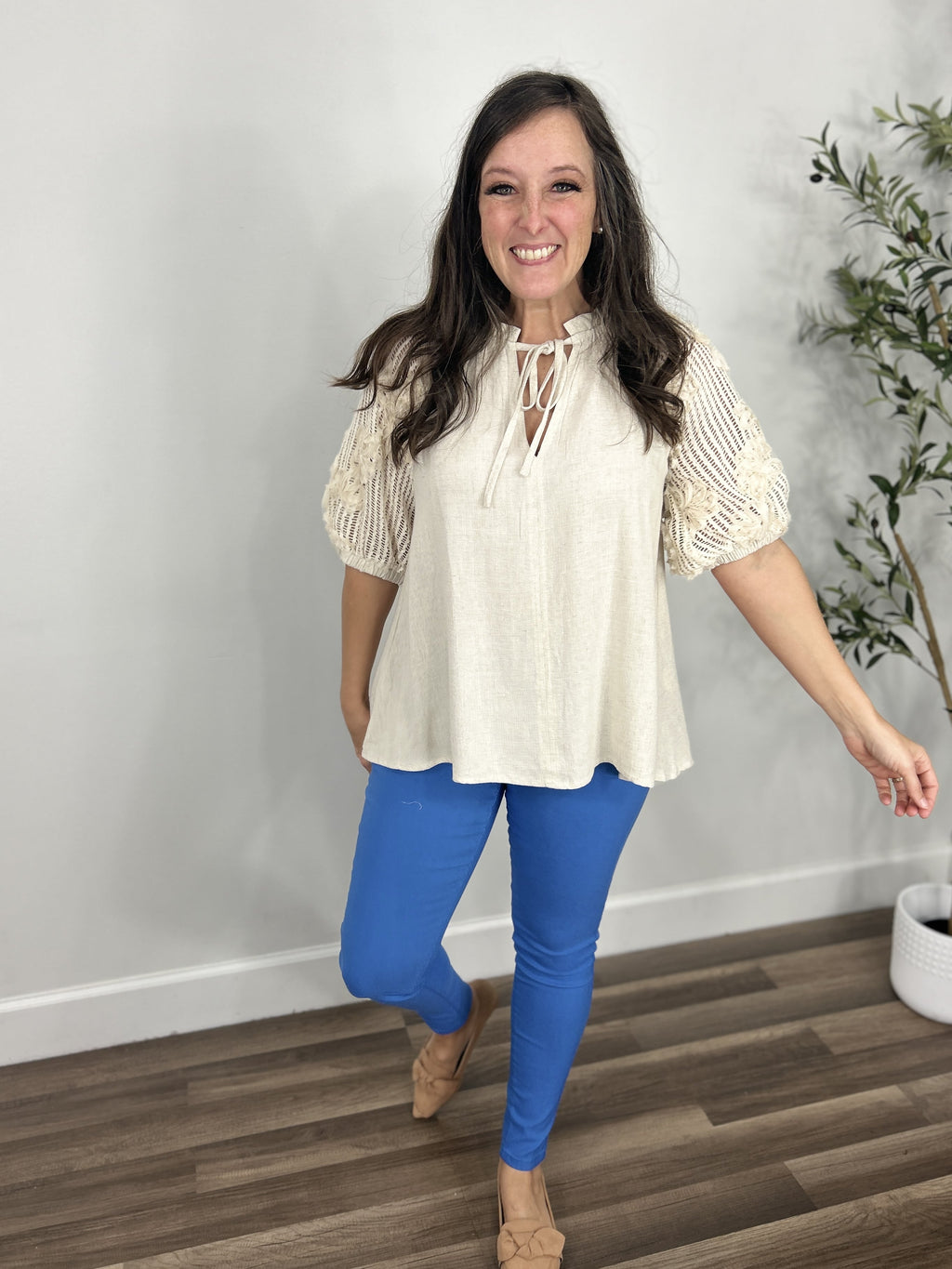 Everly v neck crochet sleeve top paired with blue Fletcher hyper stretch skinny jeans and taupe sandals.
