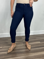 Load image into Gallery viewer, Women&#39;s navy blue skinny pants with a single button zipper fly and faux front pockets.
