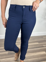 Load image into Gallery viewer, Upclose view of the navy button fly skinny jeans.
