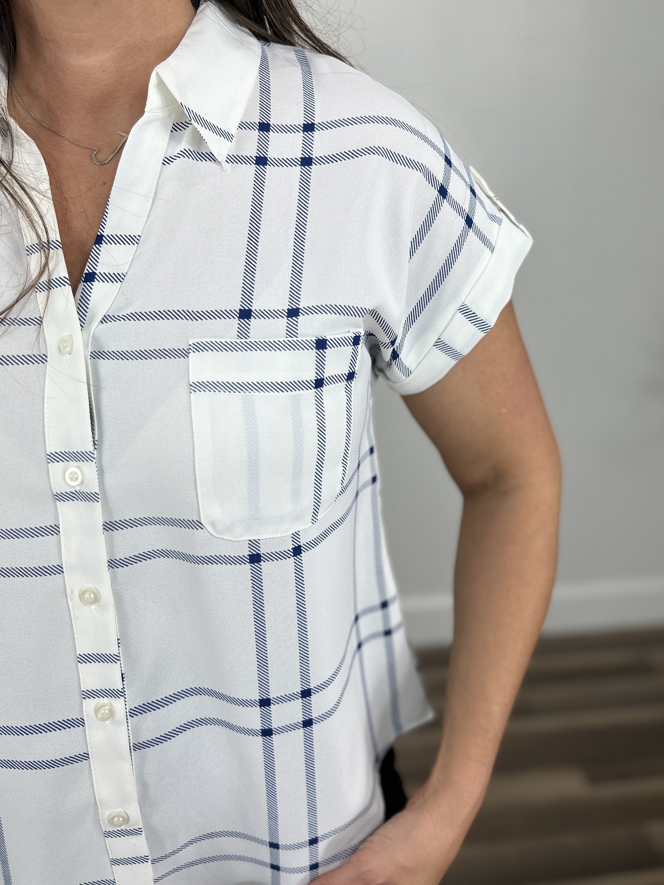 Upclose view of the blue and white Franklin button down top with front chest pocket and button detailing.
