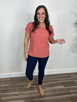Load image into Gallery viewer, Women&#39;s Ginger round neck short sleeve top in coral paired with navy blue skinny jeans and flat camel color shoes.

