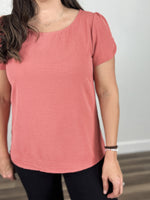 Load image into Gallery viewer, Upclose view of the Ginger round neck short sleeve top coral color and wavy texture material.
