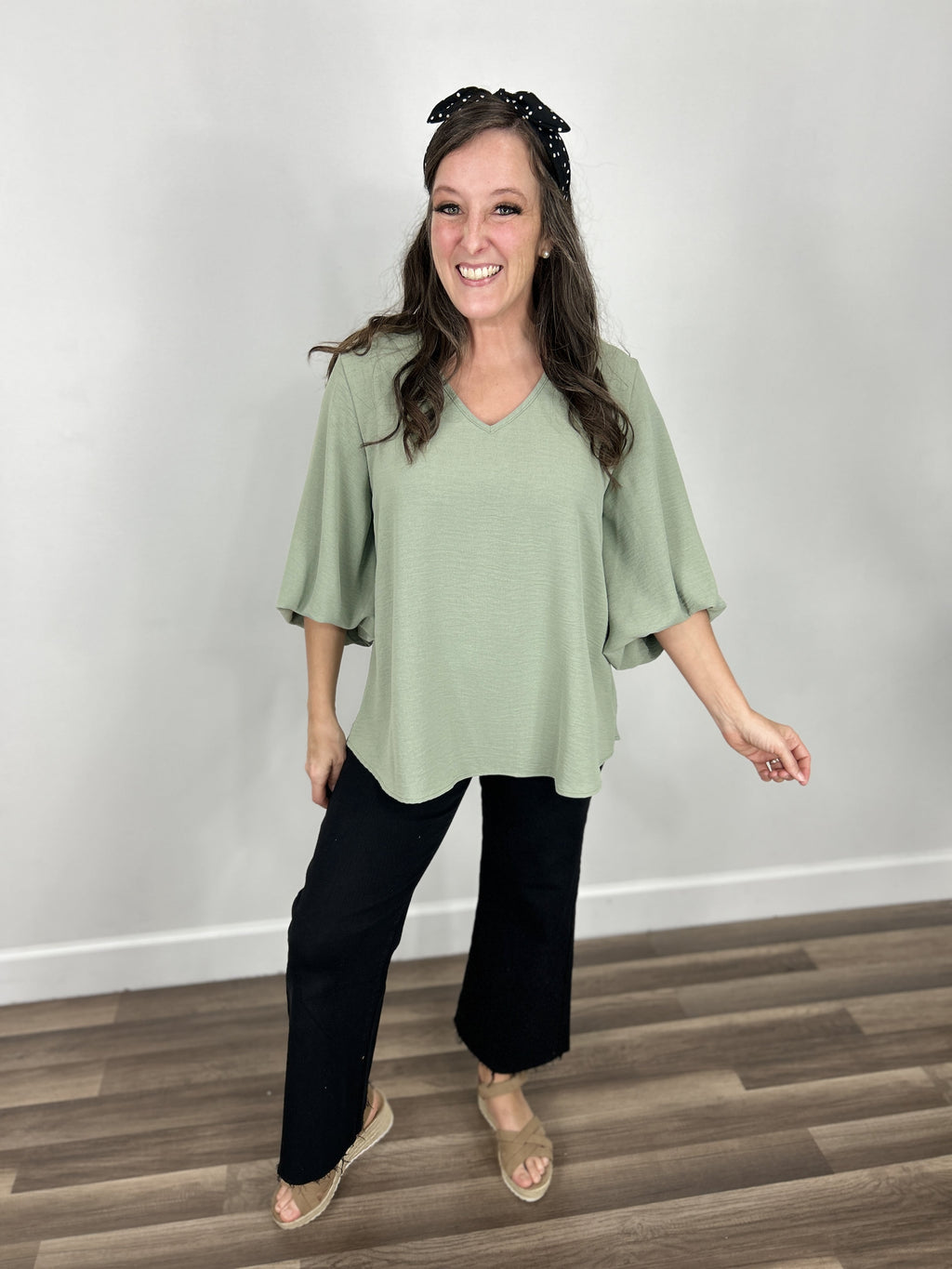 Haven Bubble Sleeve V Neck Top paired with black wide leg denim and taupe sandals.