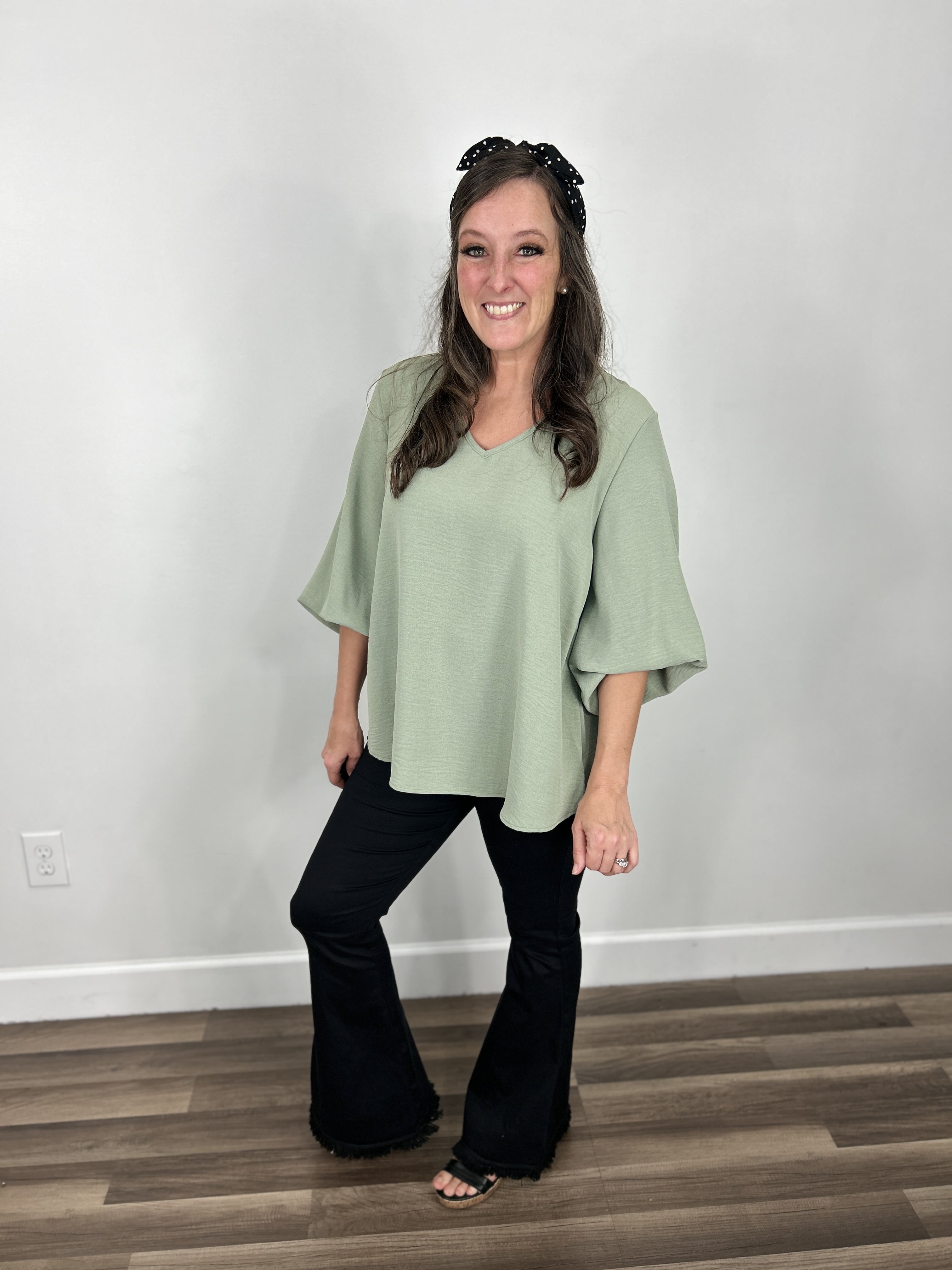 Haven Bubble Sleeve V Neck Top styled with black flare leg jeggings and black wedge sandals.