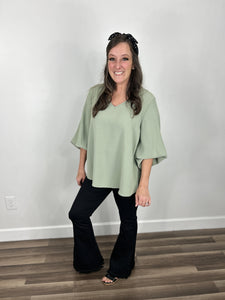 Haven Bubble Sleeve V Neck Top styled with black flare leg jeggings and black wedge sandals.