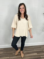 Load image into Gallery viewer, Haven Three Quarter Sleeve Ivory Top styled with charcoal skinny pants and flat shoes.
