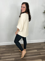 Load image into Gallery viewer, Women&#39;s Haven Three Quarter Sleeve Ivory Top back and side view paired with charcoal skinny pants.
