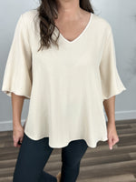 Load image into Gallery viewer, Upclose view of the women&#39;s ivory three quarter sleeve v neck top.
