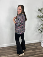 Load image into Gallery viewer, Back view of the women&#39;s Katie colorful three quarter sleeve top in multi color leopard print paired with black flare leggings and black sandals.

