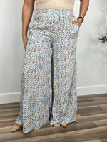 Load image into Gallery viewer, Women&#39;s multi color floral pants with flared wide legs and functional side pockets.
