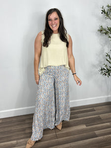 Women's linen round neck sleeveless top paired with the floral flare leg palazzo pants and camel flat shoes.