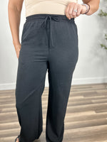 Load image into Gallery viewer, Upclose view of the black elastic waist dress pants for women.
