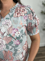 Load image into Gallery viewer, Upclose view of the smocking detail on the women&#39;s floral print top.
