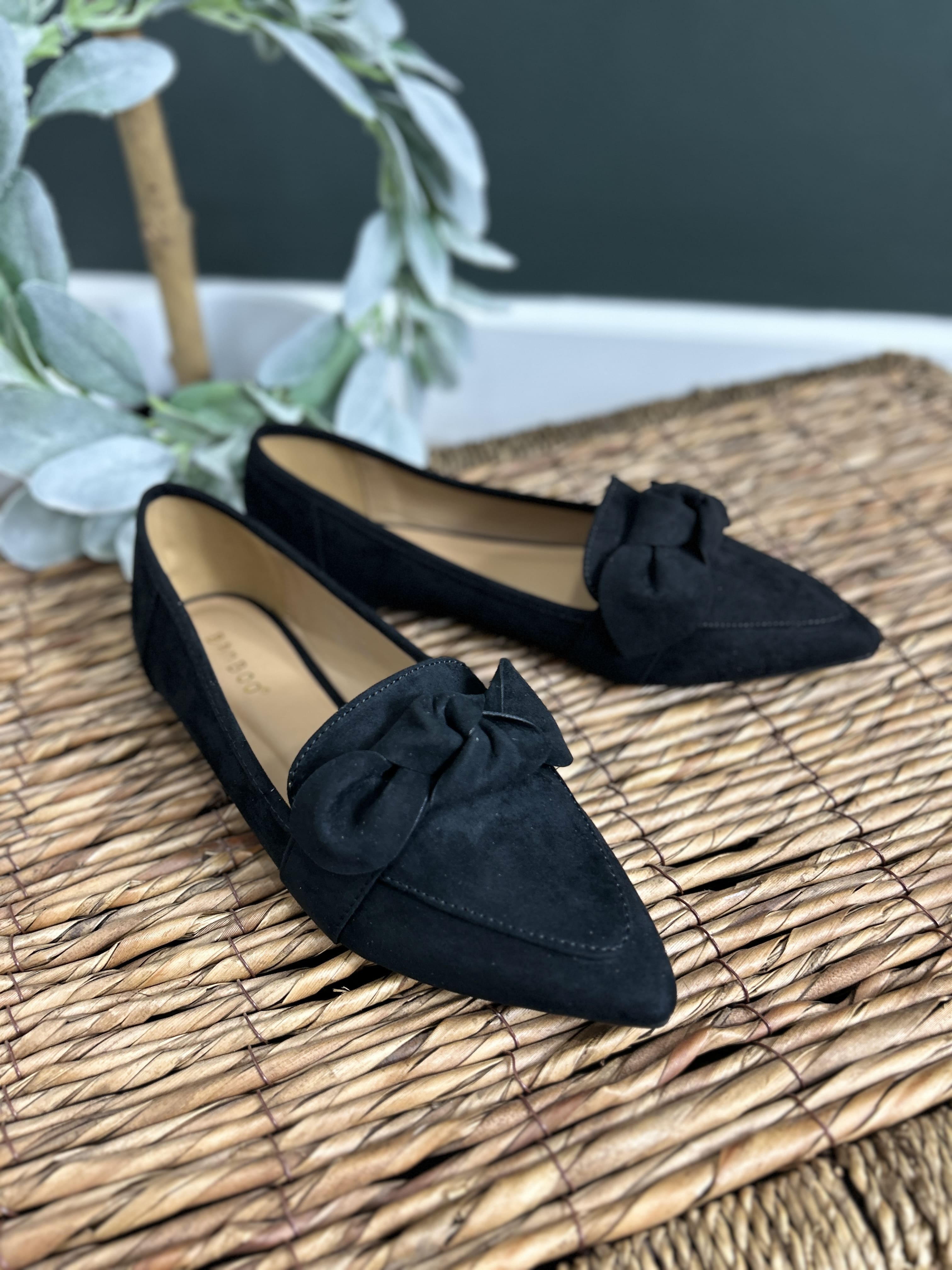 Women's Kimberly black slip on flats front view of detailing with bow accent and pointed toe.