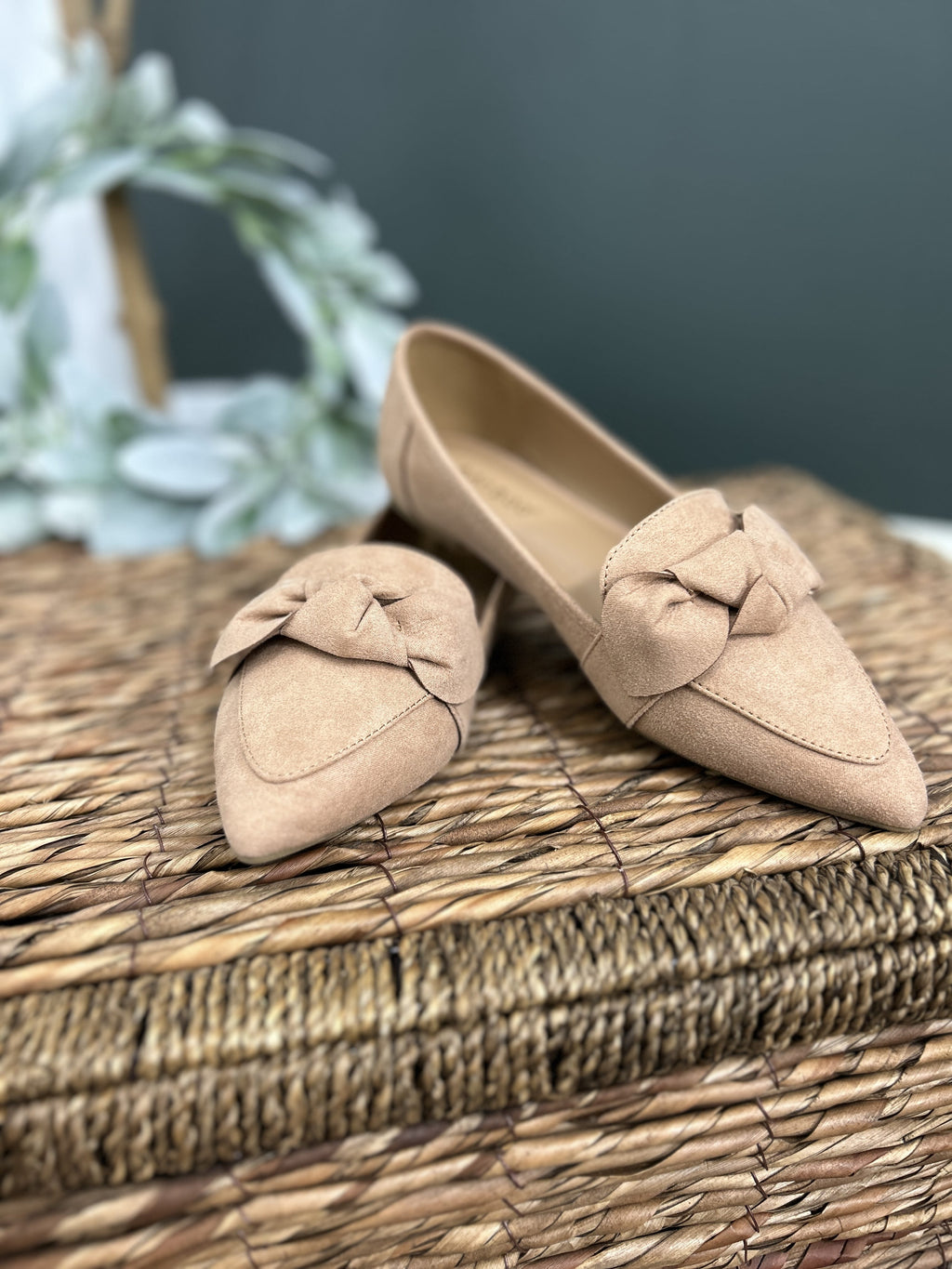 Women's loafer flat front view with accent bow detailing.