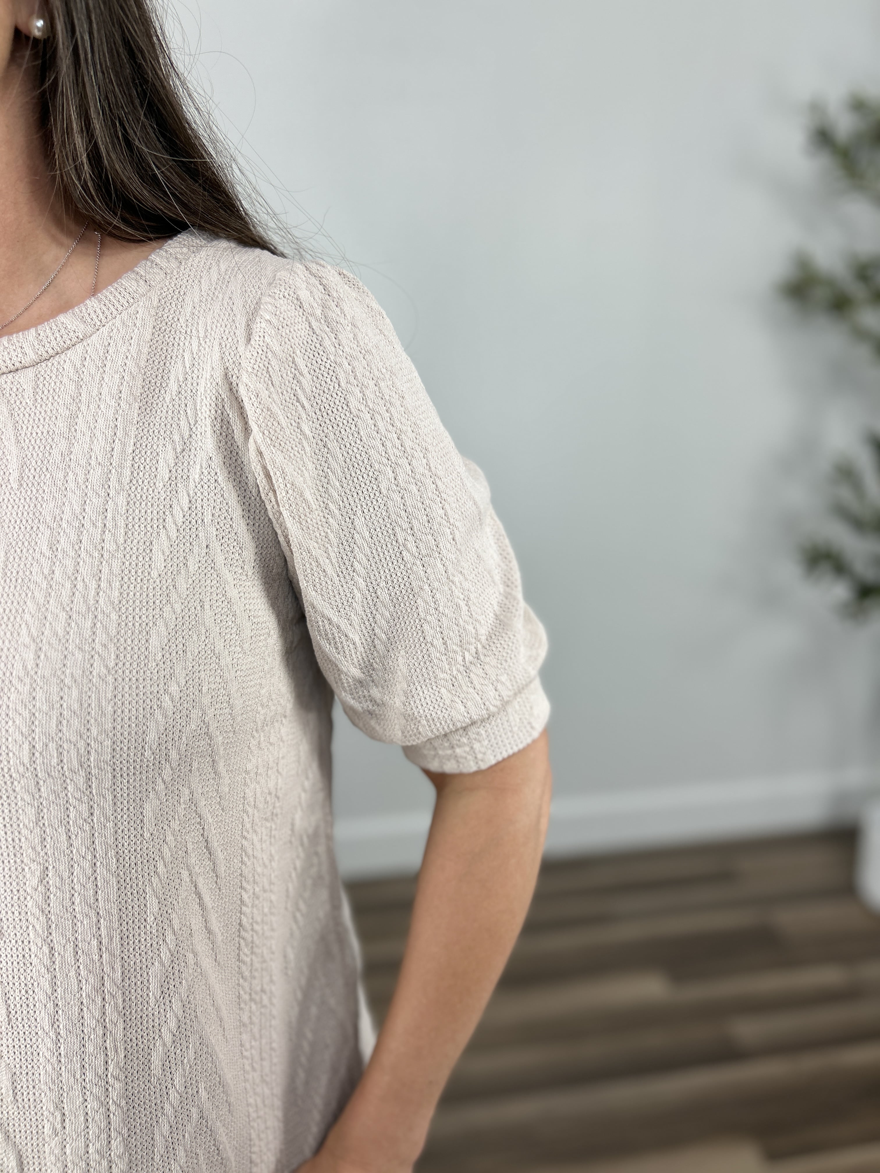 Upclose view of Lacy Cable Knit Top in oatmeal sleeve detailing.