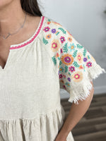 Load image into Gallery viewer, Upclose view of the multi color floral pattern on sleeves of the Laura Top.
