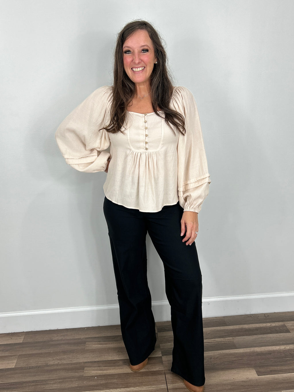 Womens Lena boho chic long sleeve top paired with black wide straight leg pants and brown boots.