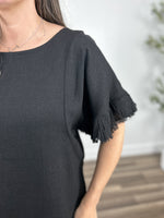 Load image into Gallery viewer, Upclose view of the short sleeve with frayed hem detailing on the lennon top.
