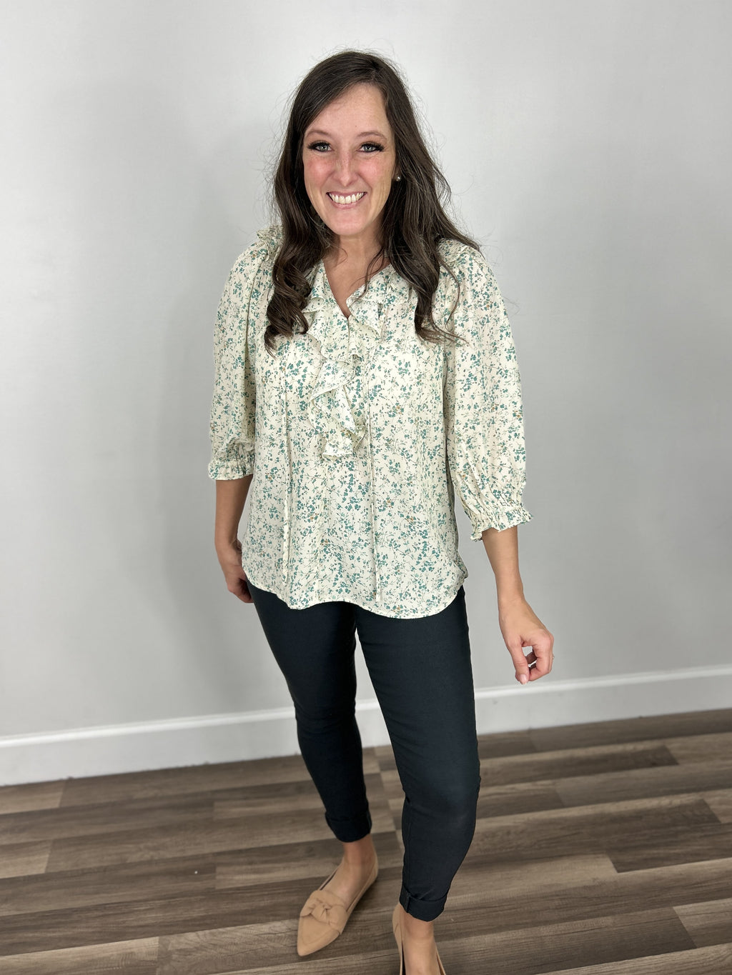 Lexie Flowery V Neck Ruffle Top paired with charcoal skinny jeans and taupe flat shoes.