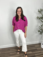 Load image into Gallery viewer, Outfit styled- women&#39;s meg magenta button up top front tucked into white crop pants and paired with black wedge sandals.
