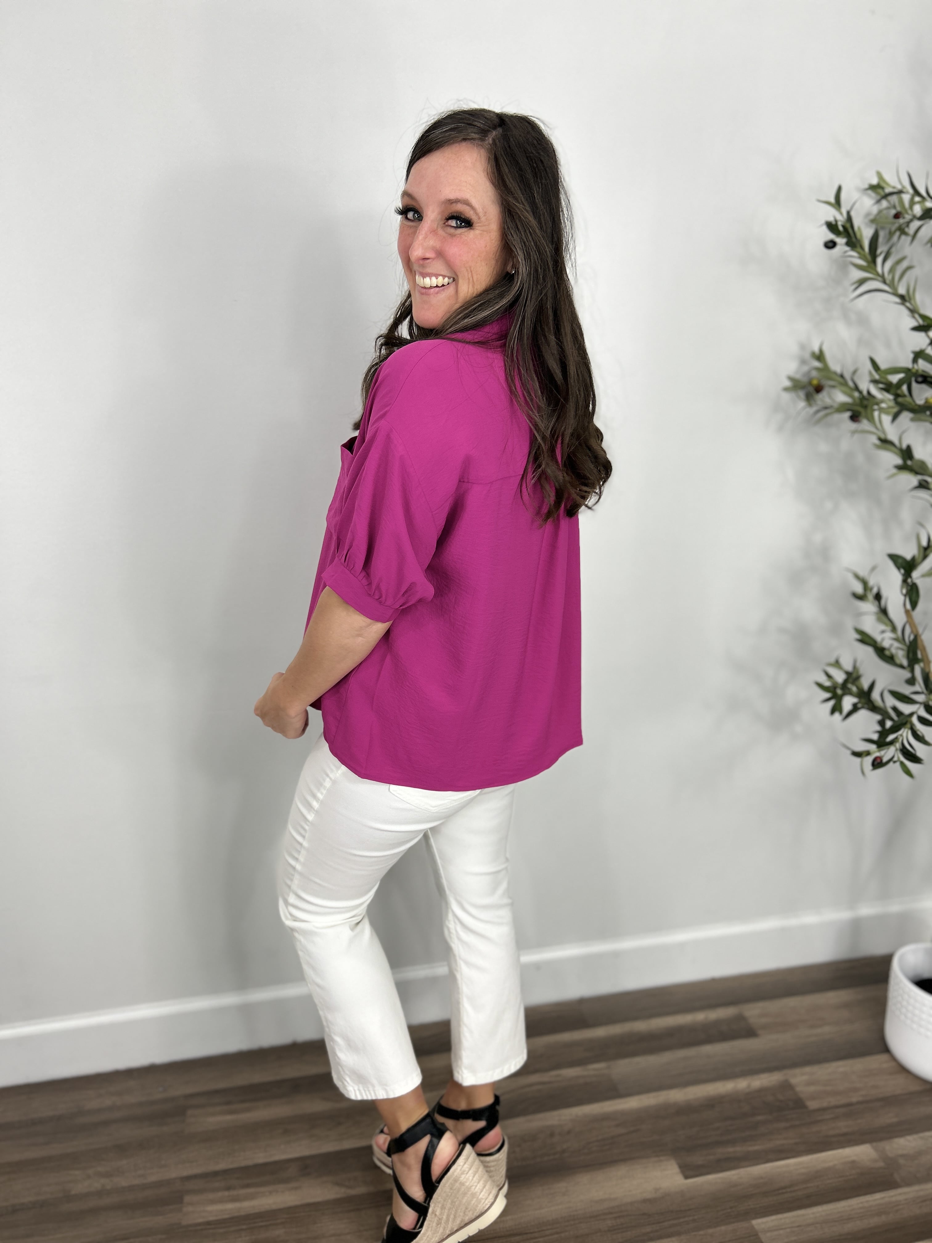Back view of the meg magenta button up top with puff short sleeves.