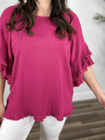Load image into Gallery viewer, Upclose view of the Meredith Linen ruffle sleeve top in hot pink. Showing the round neckline and ruffle hem detailing.
