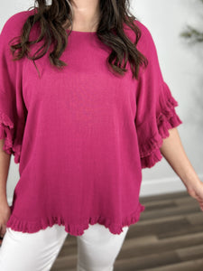 Upclose view of the Meredith Linen ruffle sleeve top in hot pink. Showing the round neckline and ruffle hem detailing.