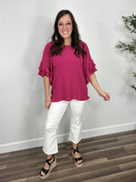 Load image into Gallery viewer, Women&#39;s fuchsia Meredith linen ruffle sleeve top paired with white crop pants and black sandals.
