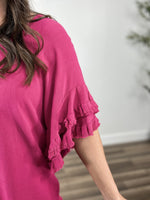 Load image into Gallery viewer, Upclose view of the women&#39;s fuchsia color ruffle sleeve top. Showing the double tier ruffle with frayed hem detailing.
