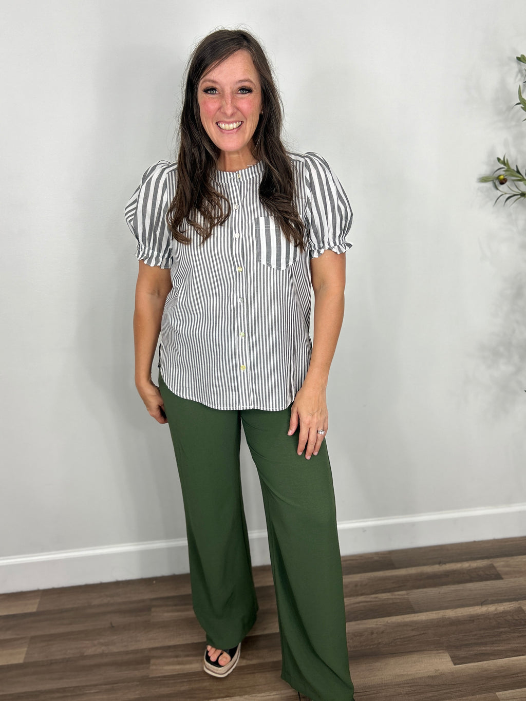 Women's Mila striped button down top paired with green straight leg pants with black wedge sandals.