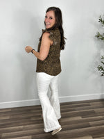 Load image into Gallery viewer, Side view of the Monica leopard print ruffle sleeve top for women paired with white flare pants.
