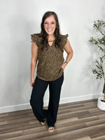 Load image into Gallery viewer, Women&#39;s leopard print ruffle sleeve top paired with black dress pants and black wedge sandals.
