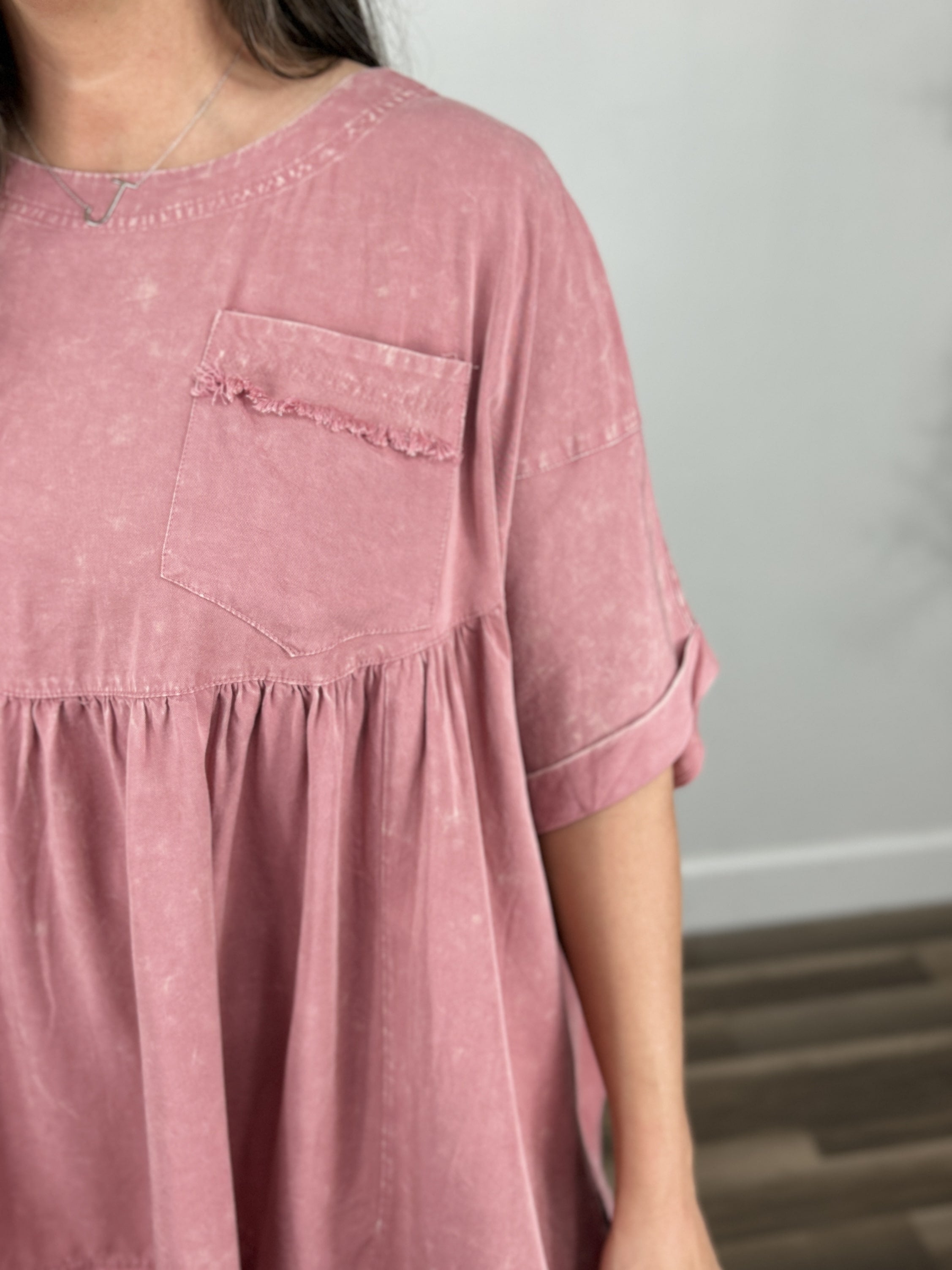 Front pocket view of the poppy oversized babydoll mineral wash top.