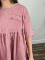 Load image into Gallery viewer, Front pocket view of the poppy oversized babydoll mineral wash top.
