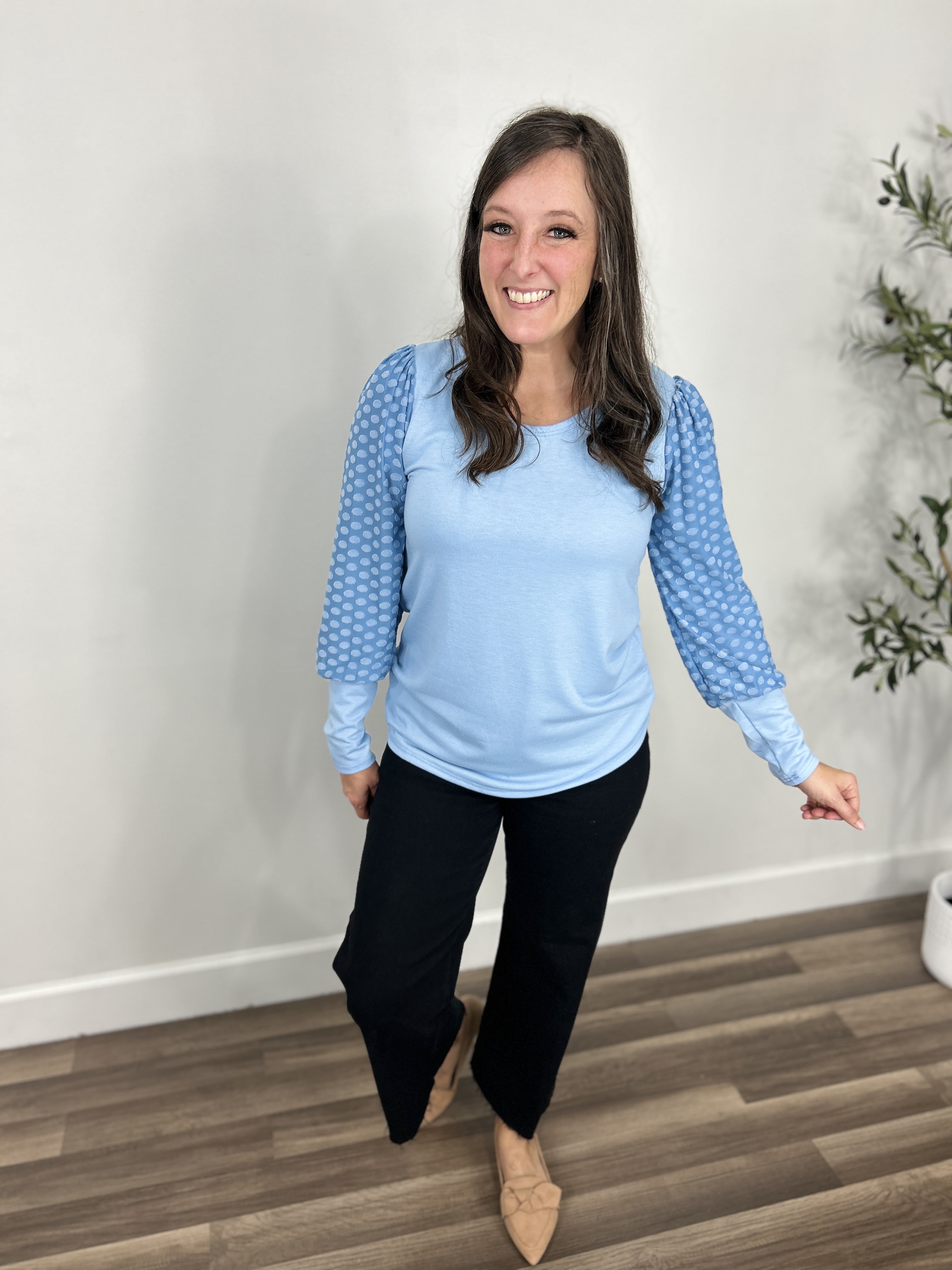Sanders blue dot sleeve round neck top paired with black wide leg denim and taupe flats.