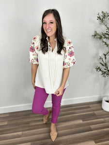 Savannah Floral Puff Sleeve Top with a v neckline styled with skinny jeans in berry and flat camel color flats.