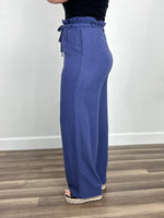 Load image into Gallery viewer, Back view of the women&#39;s linen wide leg pant in blue.
