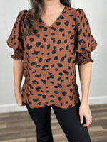 Load image into Gallery viewer, Tiffany Short Sleeve Animal Print Top upclose view of brown top with large black leopard print spots.
