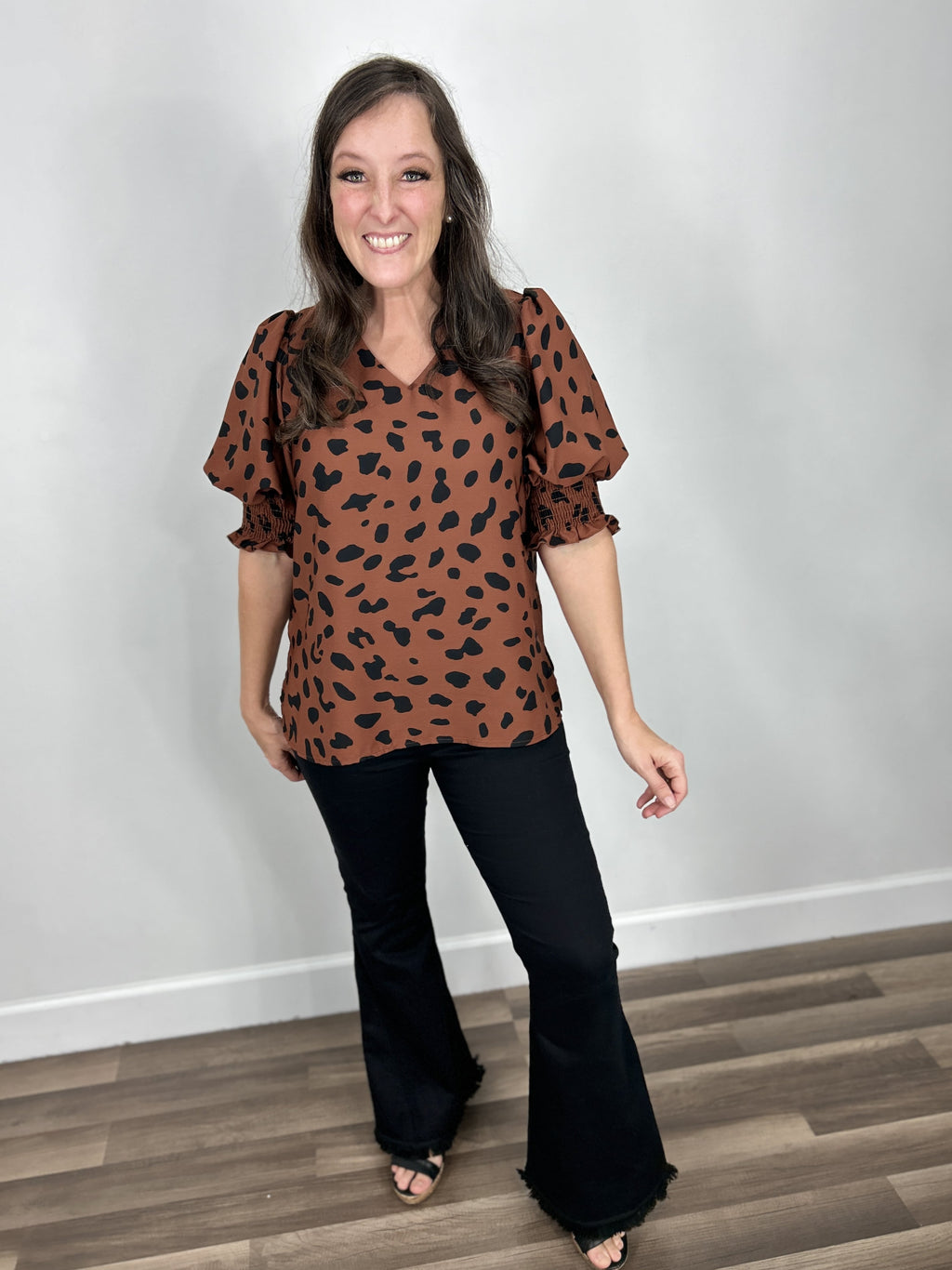 Tiffany Short Sleeve Animal Print Top main outfit paired with black flare pants.