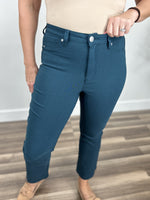 Load image into Gallery viewer, Upclose view of single button closure and belt loops on the Wyatt stretch flare crop pants in teal 
