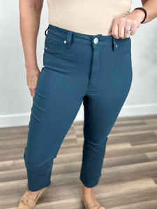 Upclose view of single button closure and belt loops on the Wyatt stretch flare crop pants in teal 
