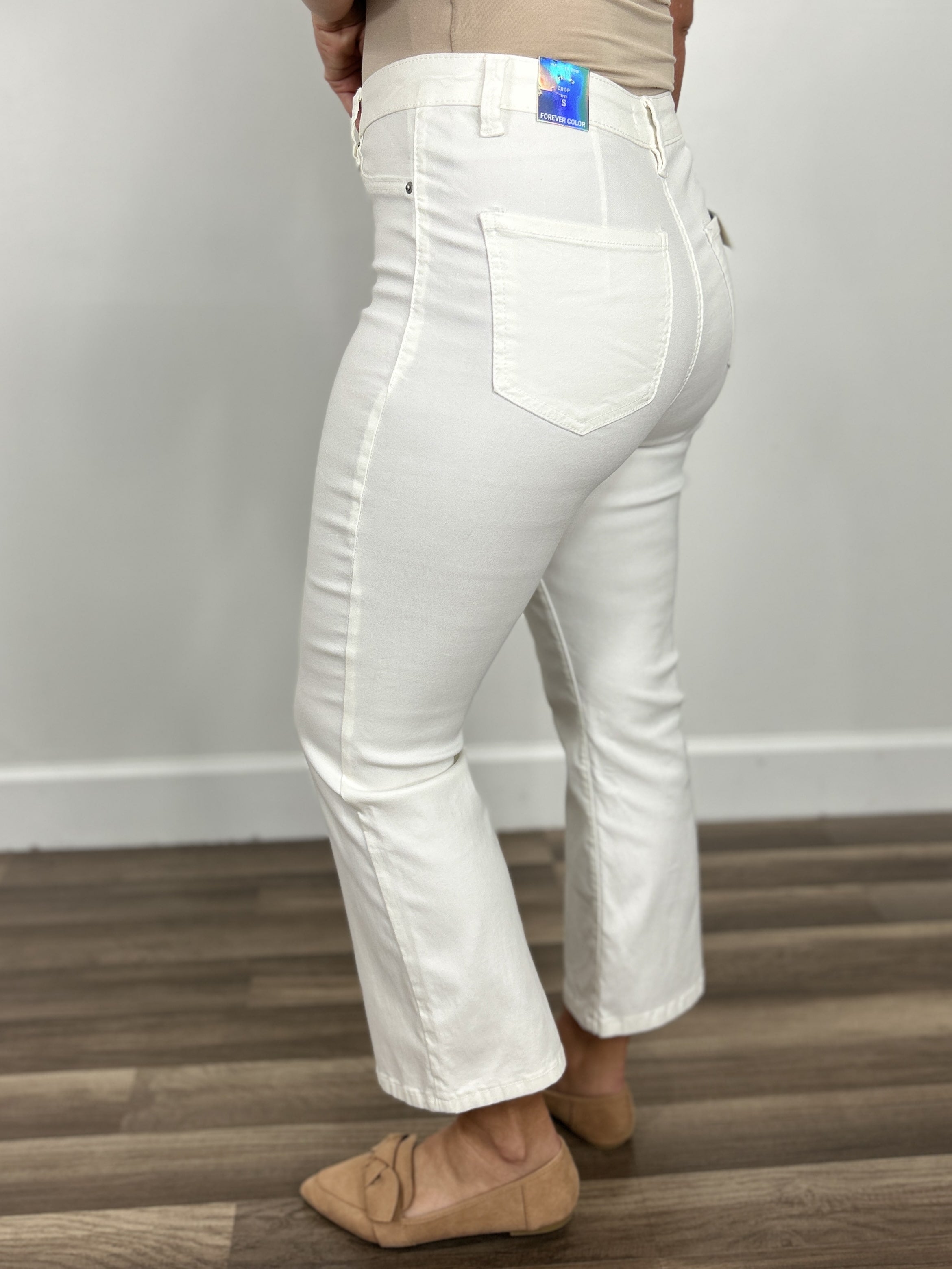 Side view of the women's white Wyatt stretchy flare cropped pants.